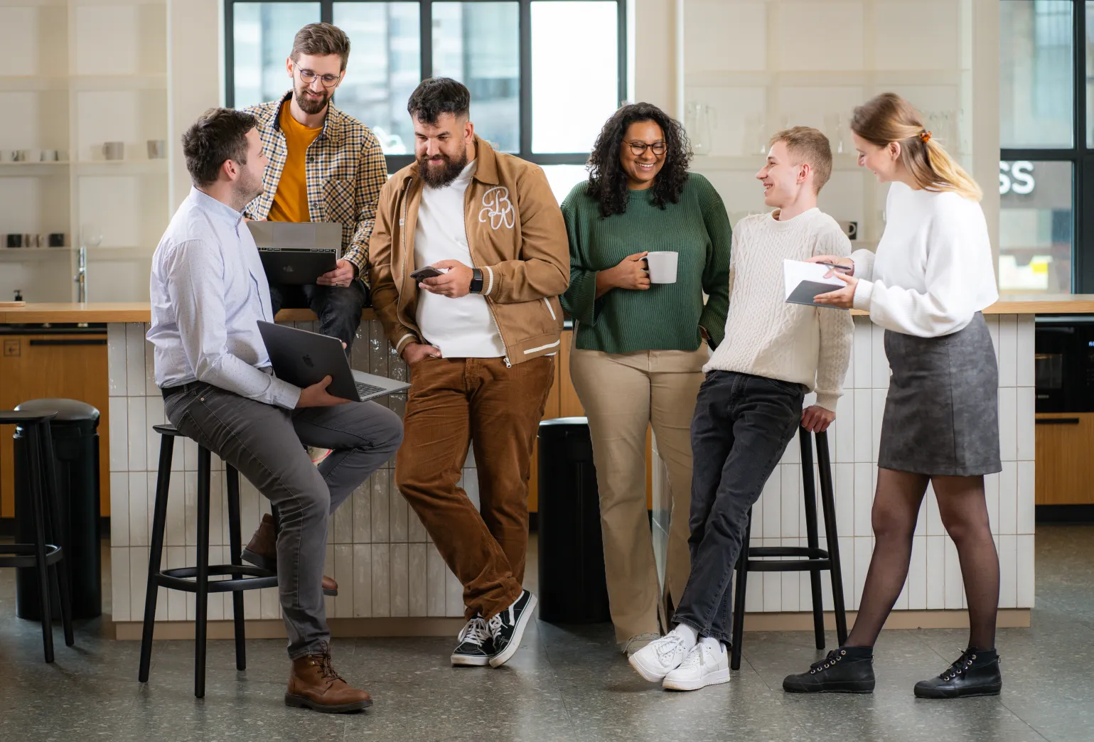 A team of Mark We Trust - freelance collective, casually standing and discussing projects.
