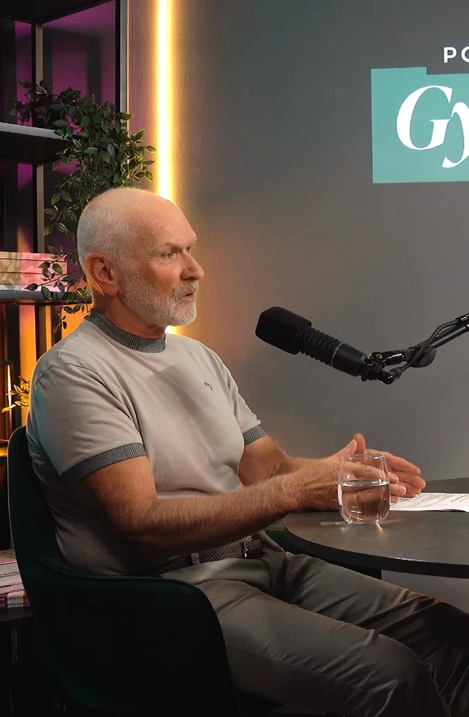 Guest speaking at the microphone during a podcast recording in the studio.